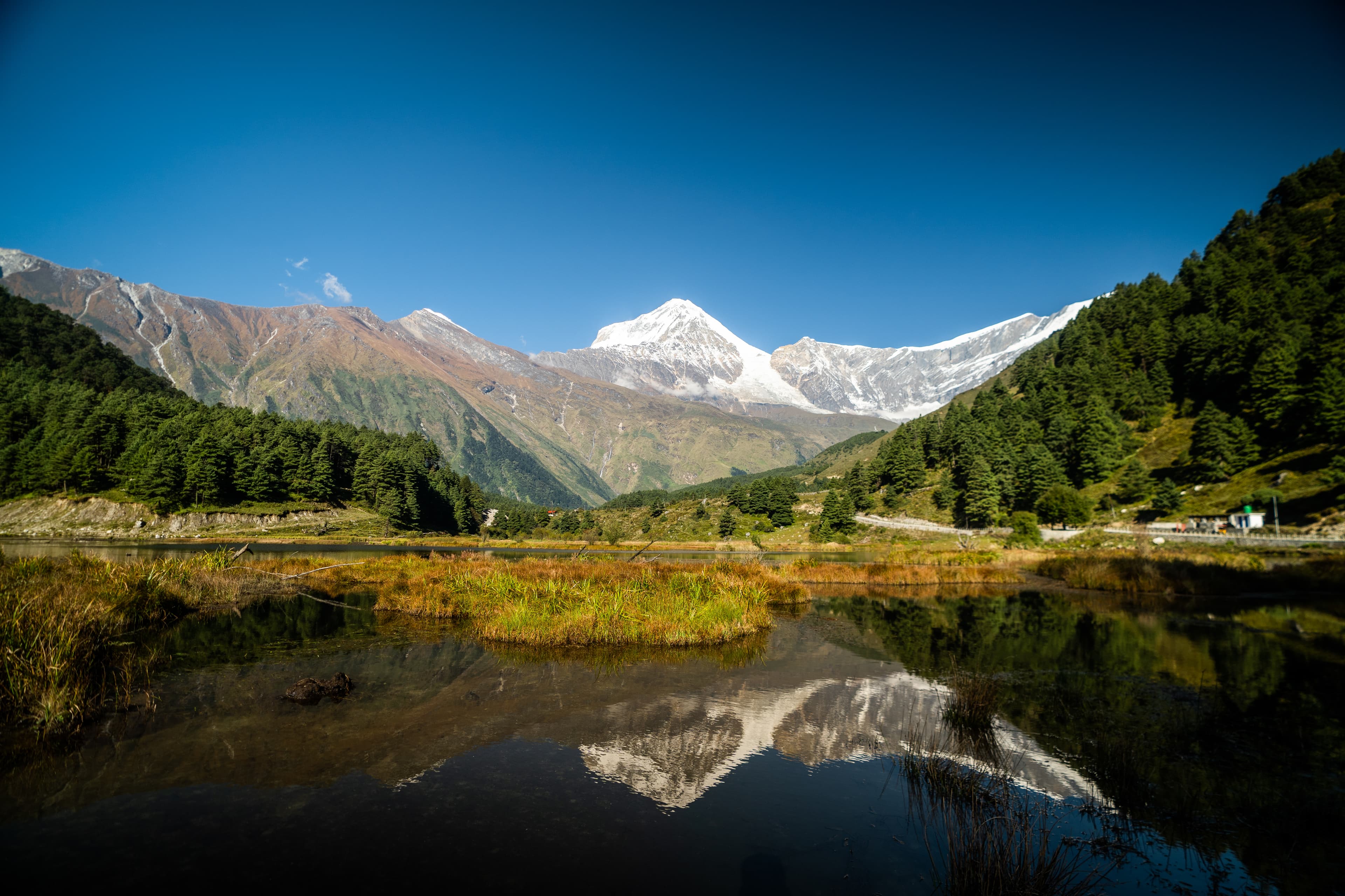 Snow peaks mirrored at midday